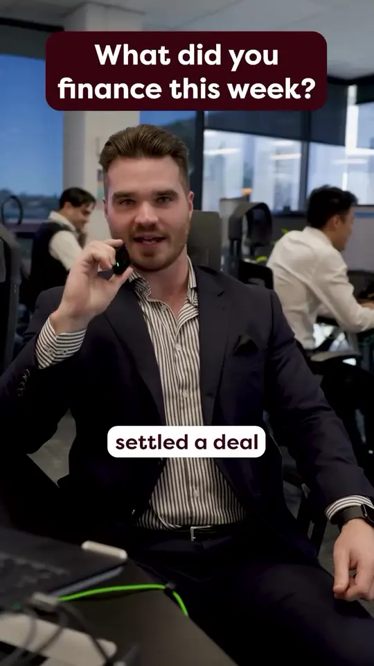 A Find A Loan broker on the phone in their office, captioned settled a deal.